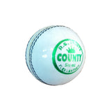 Light blue cricket ball with green text on a white background